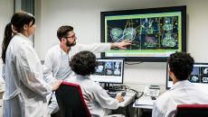 Group of doctors looking at a monitor