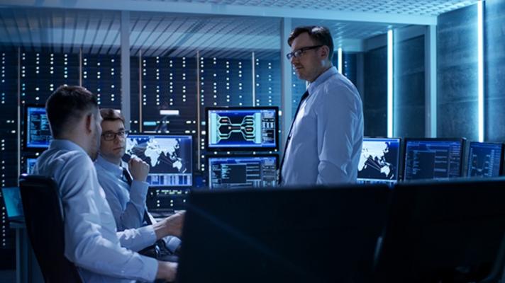 A meeting of people in a computer server room