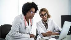 Doctors looking at a computer