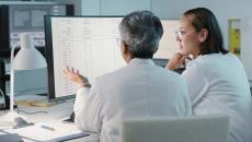 Healthcare workers looking at data on a monitor