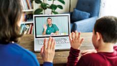 Parent and child attending telehealth appointment