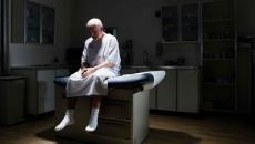 Patient sitting on doctors office bed