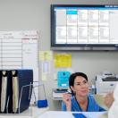 Staff conversing in the nurses' station with the Ascom Digistat Smart Central on the background