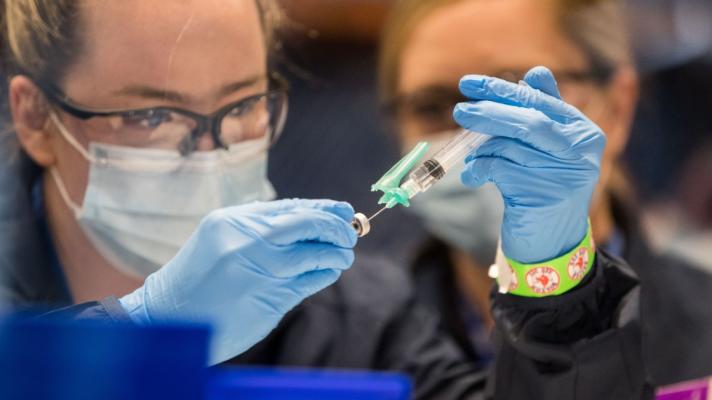 A healthcare worker prepares the COVID-19 vaccine