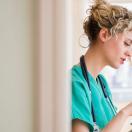 A nurse holding a digital tablet to check a patient's file