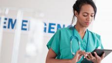 Healthcare worker using a tablet in a hospital